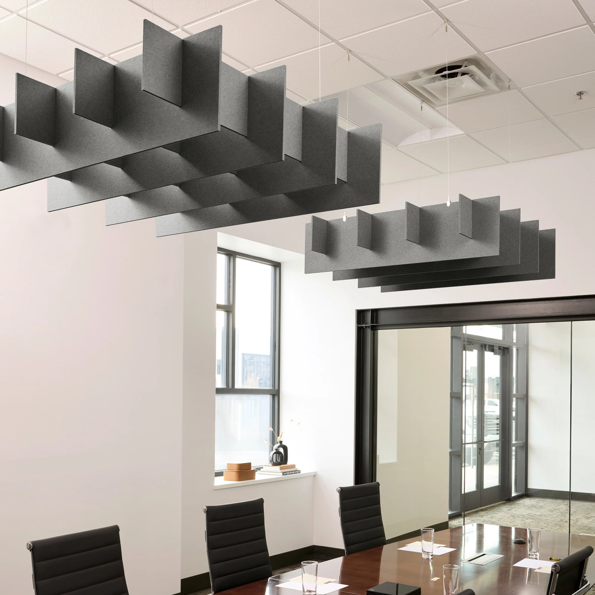 Grid 3D Cloud acoustic ceiling baffles in Armor felt above a conference table