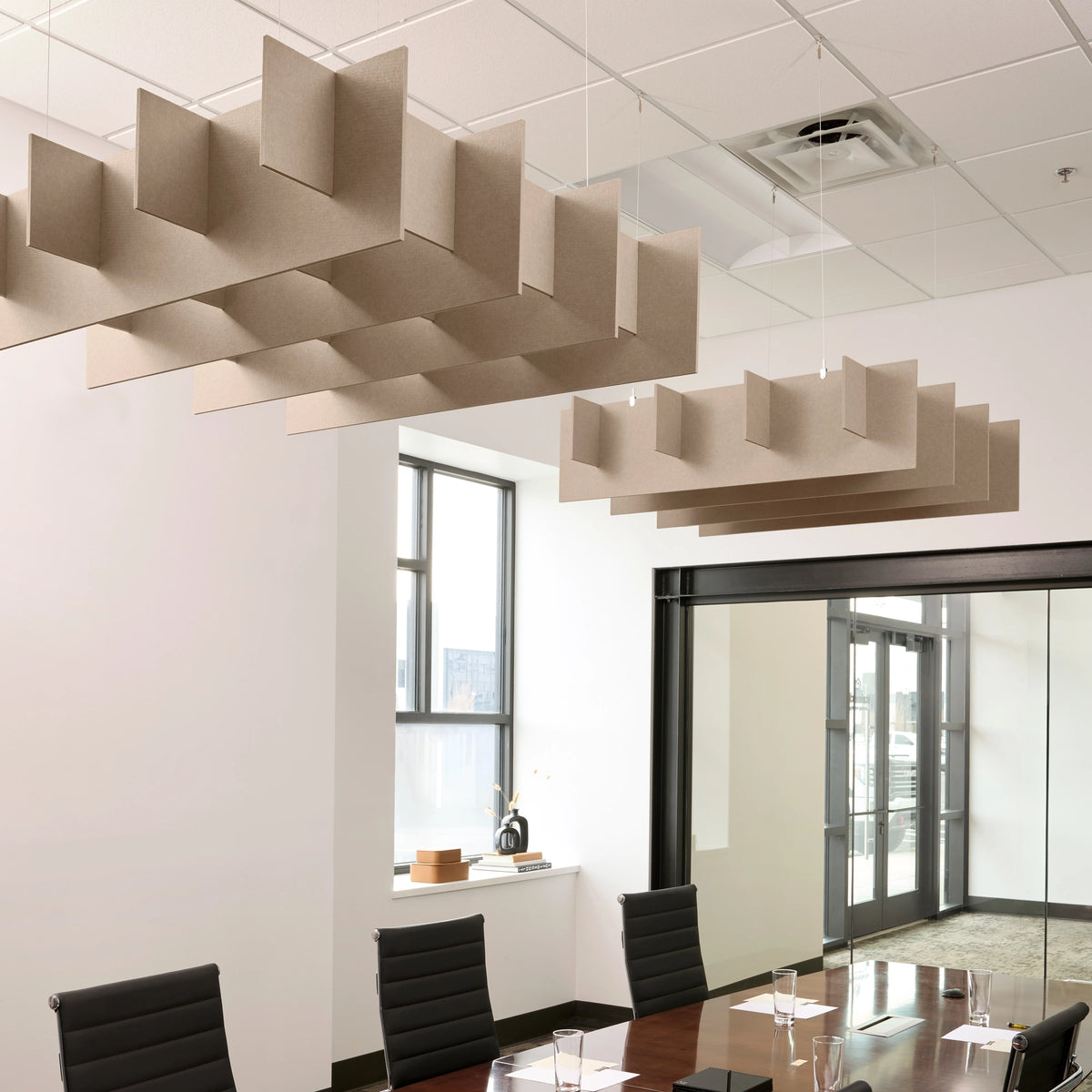 Grid 3D Cloud acoustic ceiling baffles in Cashmere felt above a conference table
