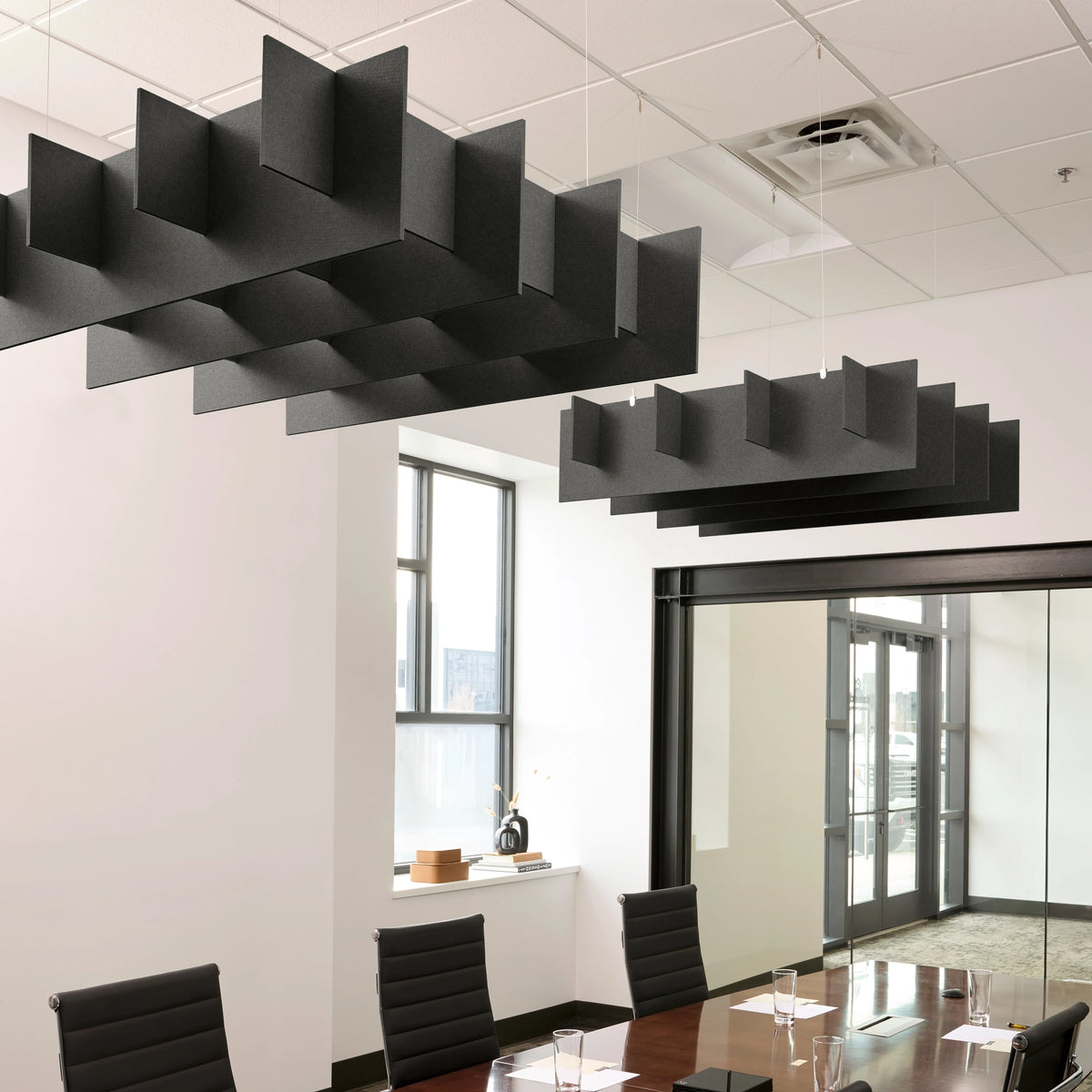 Grid 3D Cloud acoustic ceiling baffles in Cast felt above a conference table