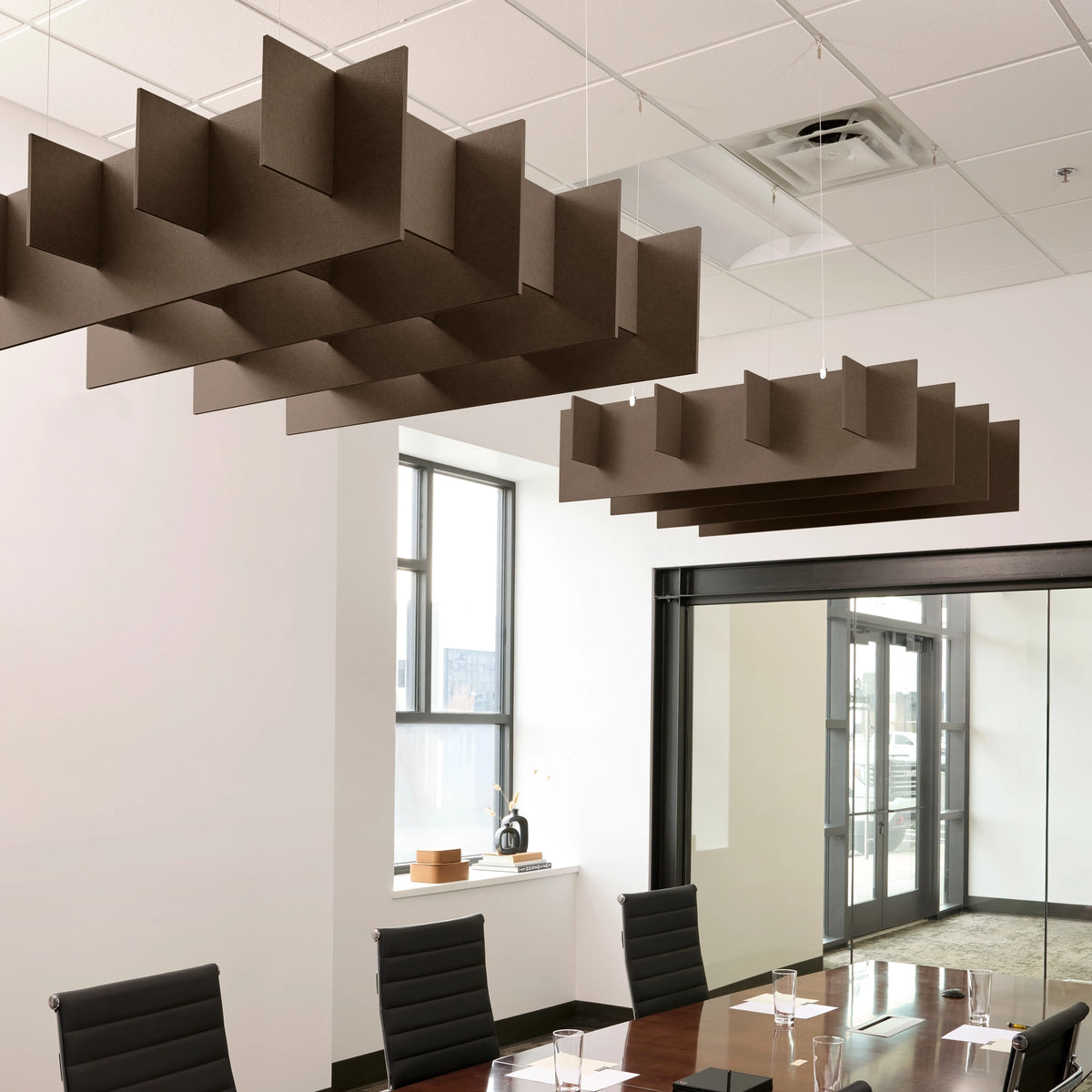 Grid 3D Cloud acoustic ceiling baffles in Cocoa felt above a conference table