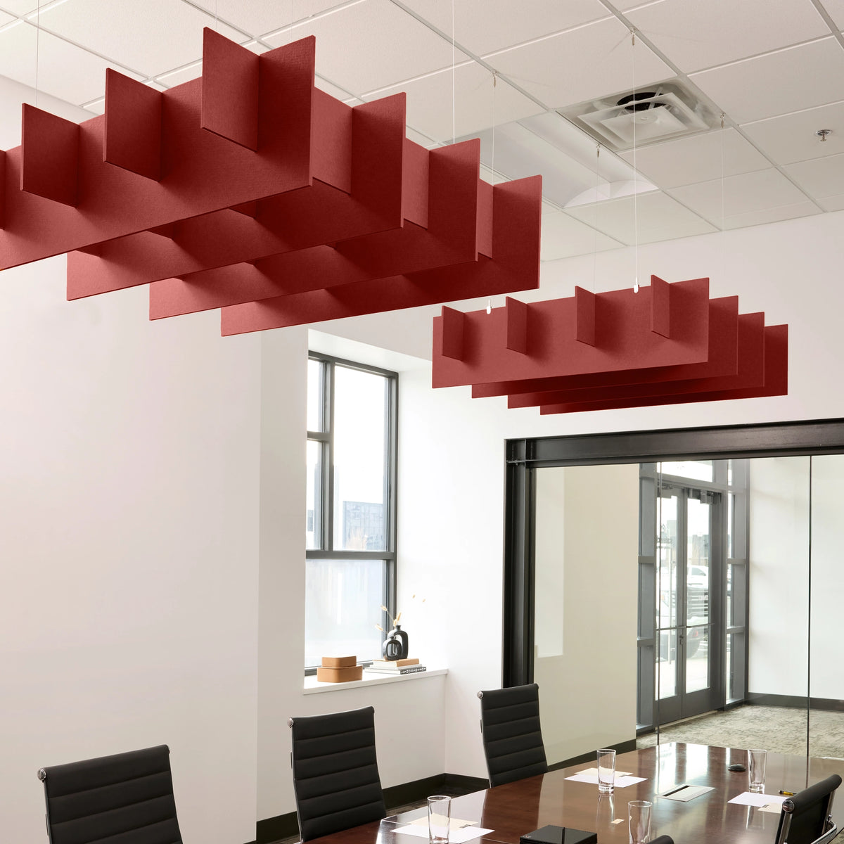 Grid 3D Cloud acoustic ceiling baffles in Crimson felt above a conference table