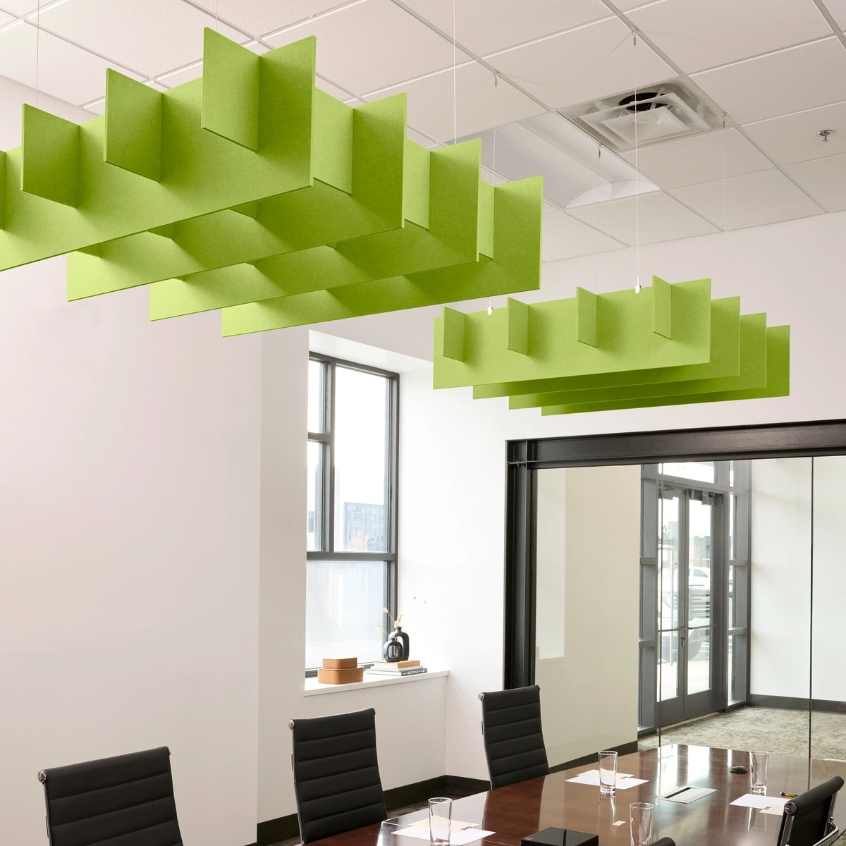 Grid 3D Cloud acoustic ceiling baffles in Kiwi felt above a conference table