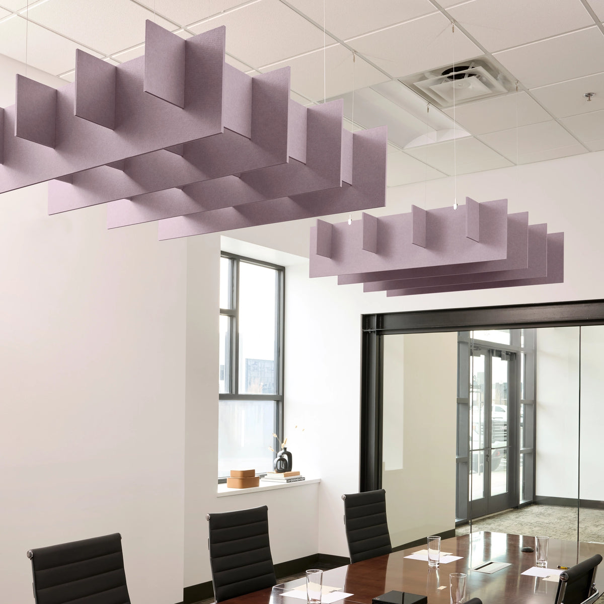 Grid 3D Cloud acoustic ceiling baffles in Lilac felt above a conference table