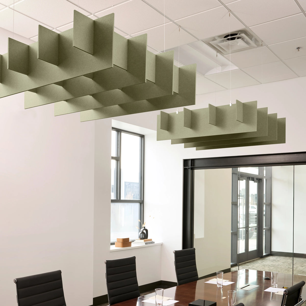 Grid 3D Cloud acoustic ceiling baffles in Sage felt above a conference table