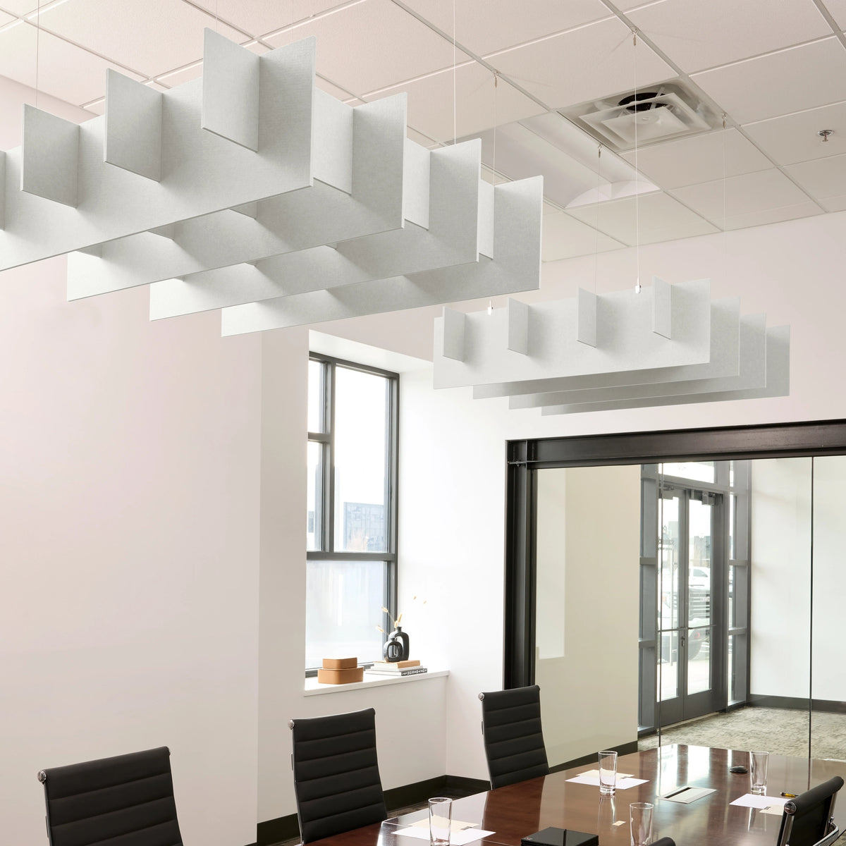 Grid 3D Cloud acoustic ceiling baffles in Zinc felt above a conference table