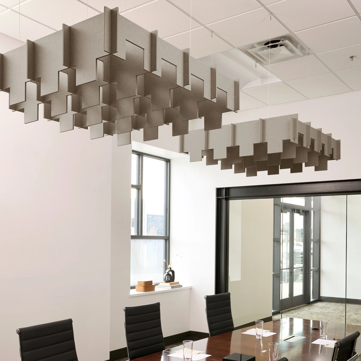 Drop 3D Cloud acoustic ceiling baffles in Ash felt above a conference table