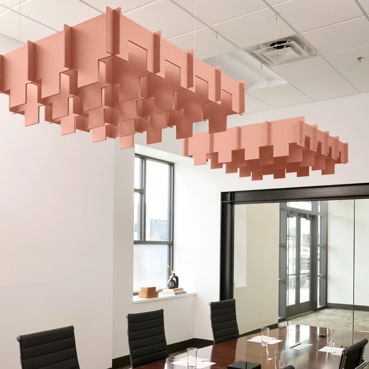 Drop 3D Cloud acoustic ceiling baffles in Coral felt above a conference table