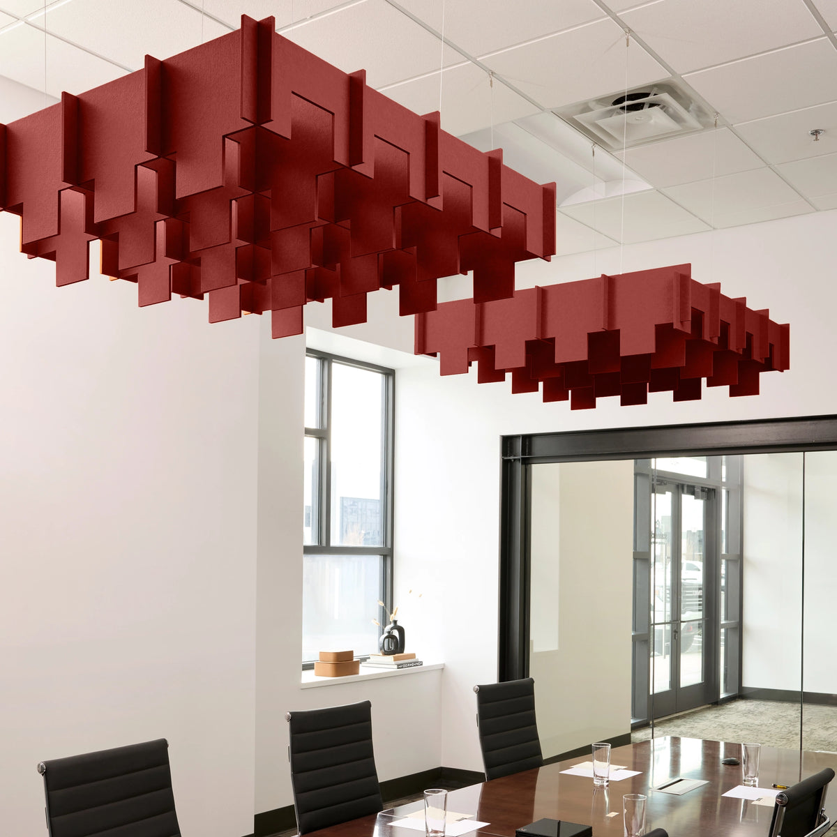Drop 3D Cloud acoustic ceiling baffles in Crimson felt above a conference table