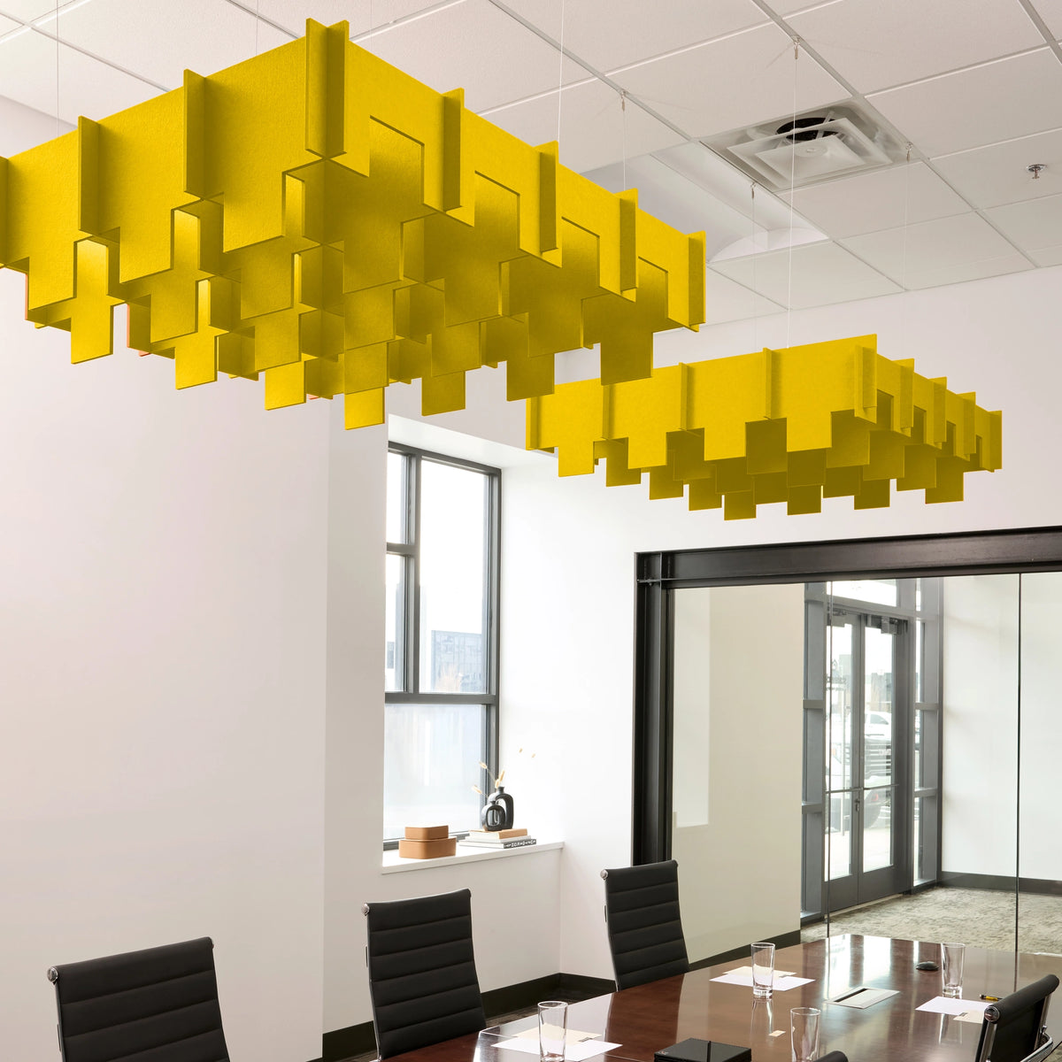 Drop 3D Cloud acoustic ceiling baffles in Dandelion felt above a conference table