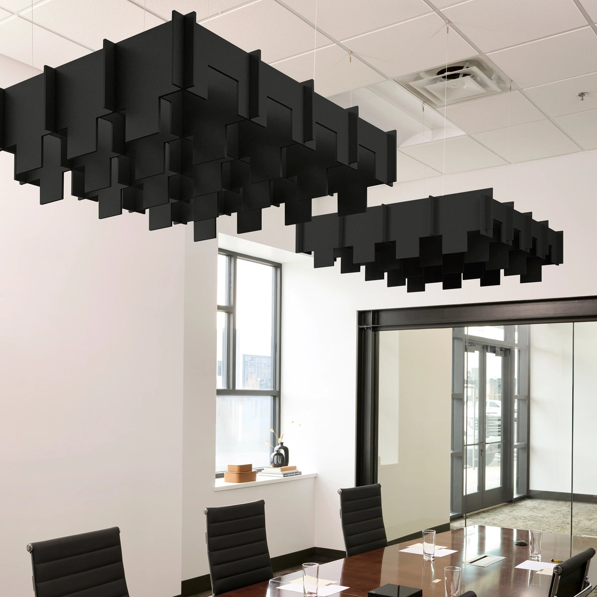 Drop 3D Cloud acoustic ceiling baffles in Ebony felt above a conference table