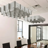Drop 3D Cloud acoustic ceiling baffles in Fog felt above a conference table