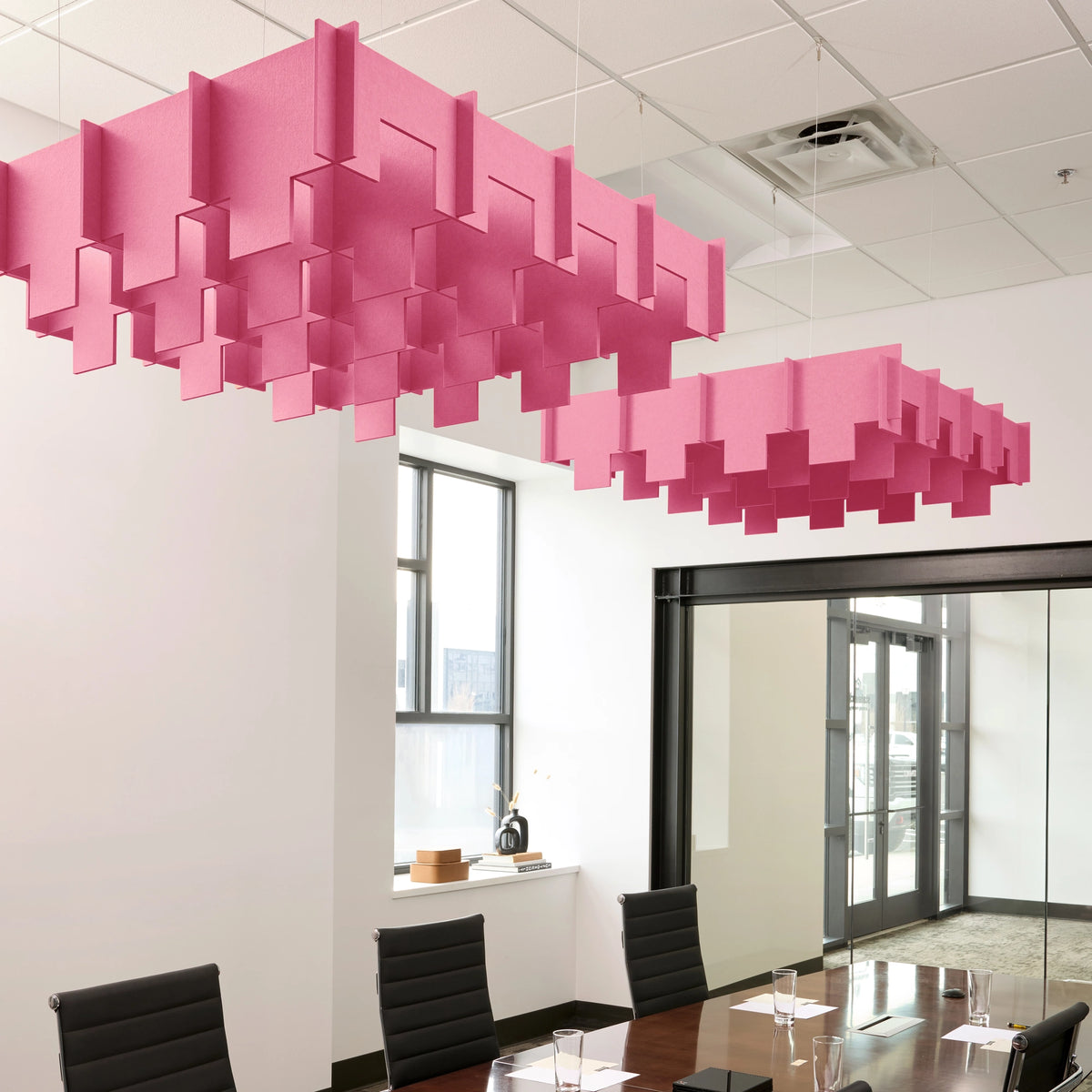 Drop 3D Cloud acoustic ceiling baffles in Hot Pink felt above a conference table