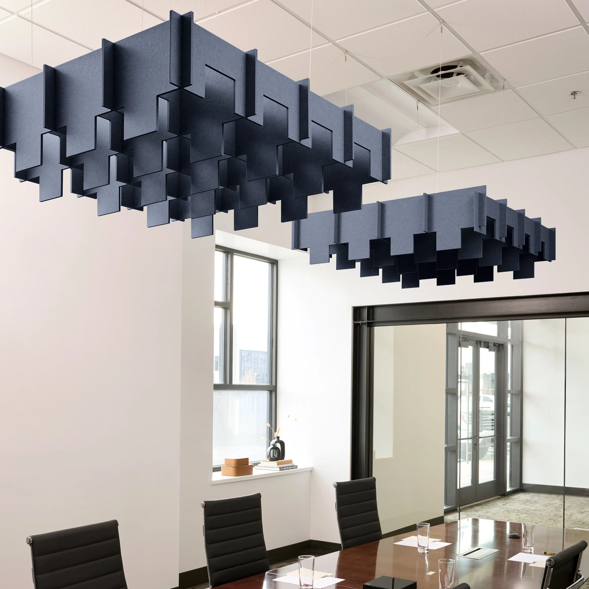 Drop 3D Cloud acoustic ceiling baffles in Indigo felt above a conference table