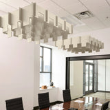 Drop 3D Cloud acoustic ceiling baffles in Ivory felt above a conference table