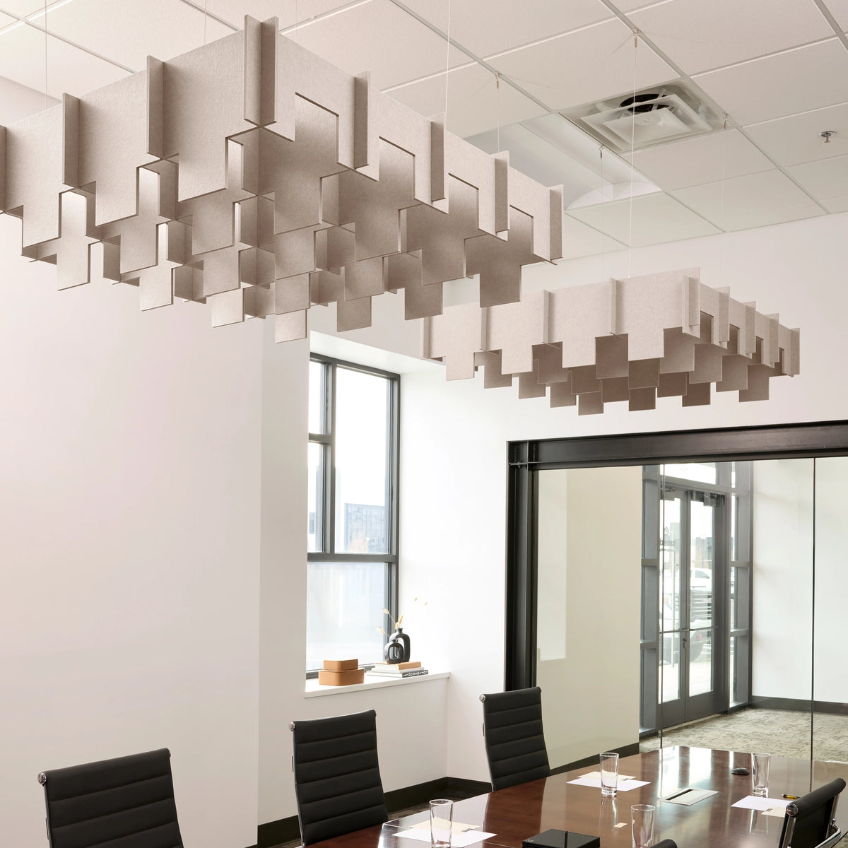 Drop 3D Cloud acoustic ceiling baffles in Latte felt above a conference table