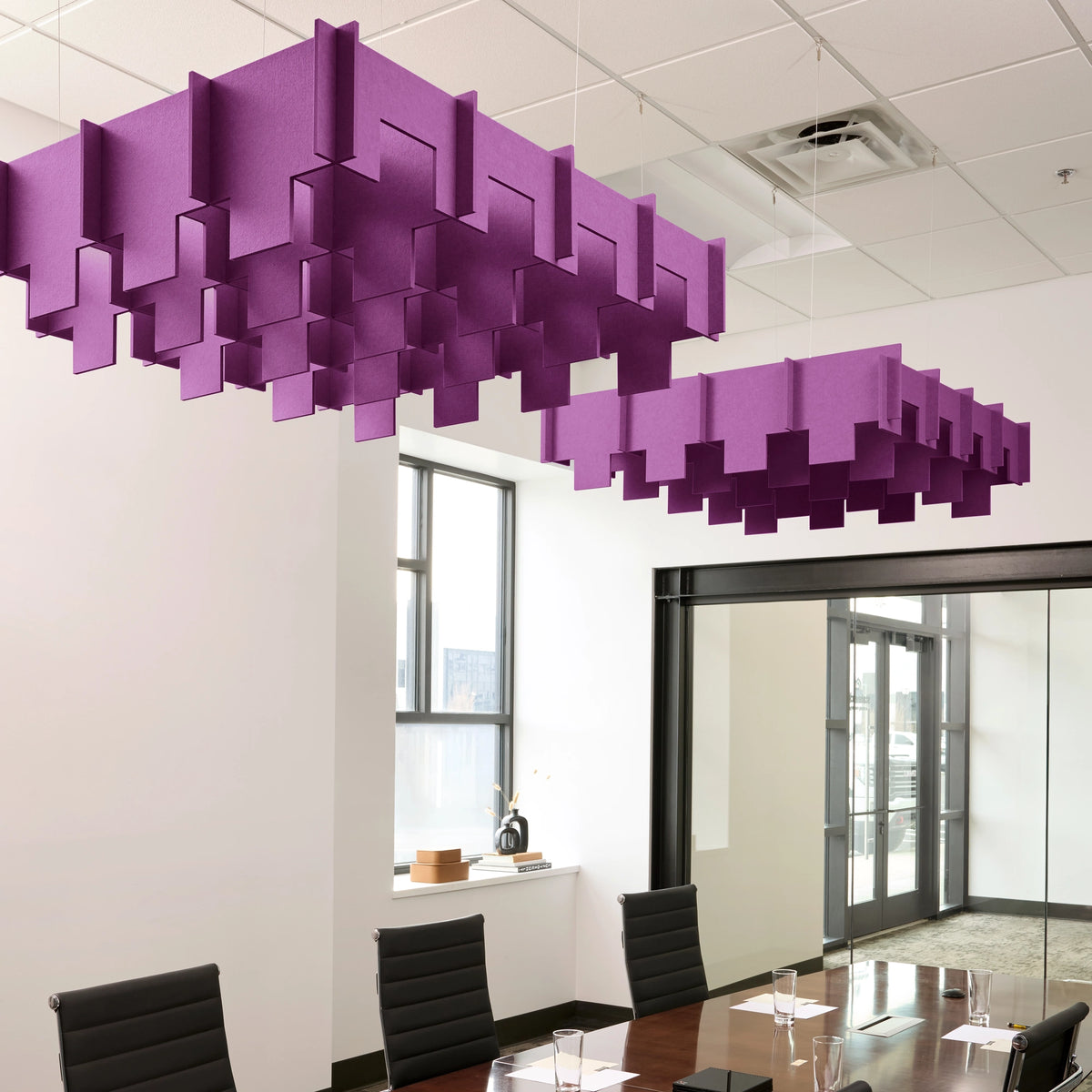 Drop 3D Cloud acoustic ceiling baffles in Lavender felt above a conference table