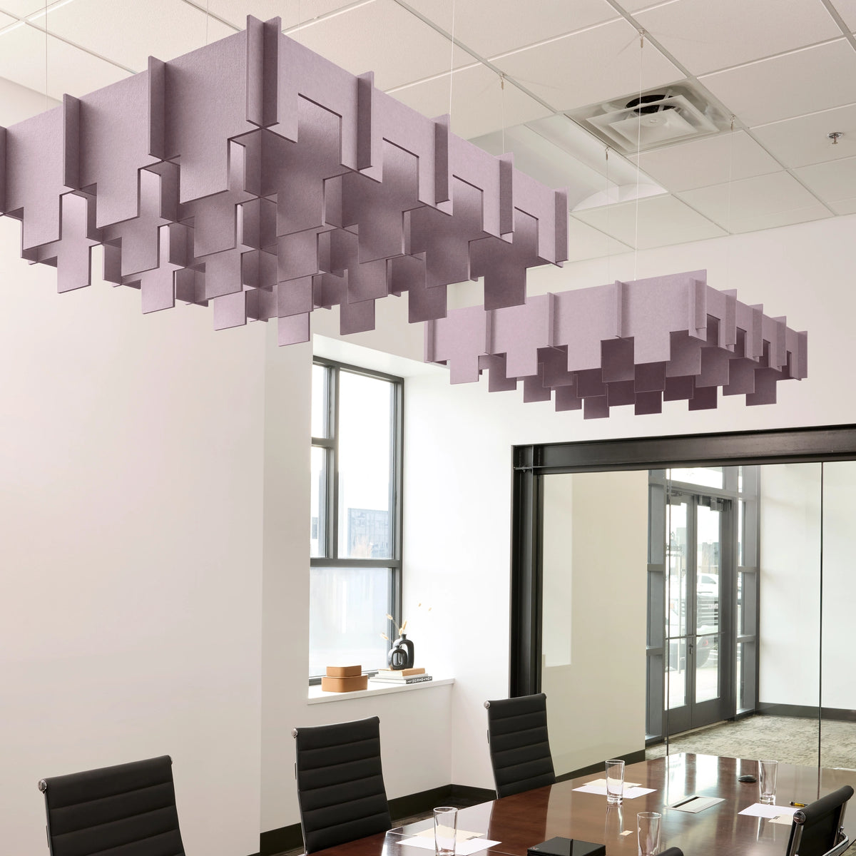 Drop 3D Cloud acoustic ceiling baffles in Lilac felt above a conference table