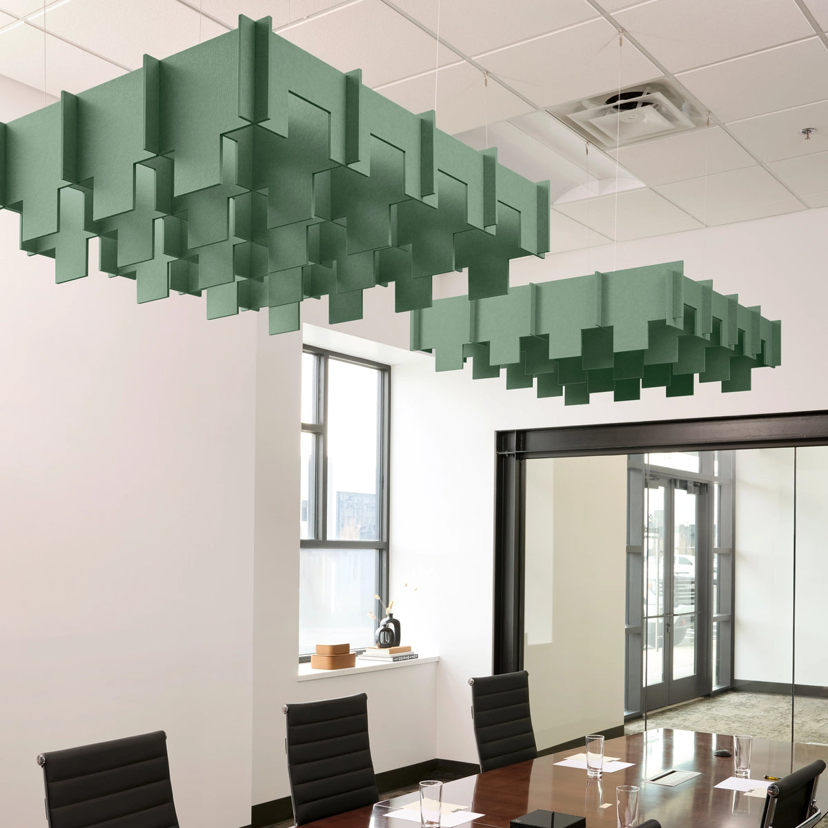 Drop 3D Cloud acoustic ceiling baffles in Mint felt above a conference table