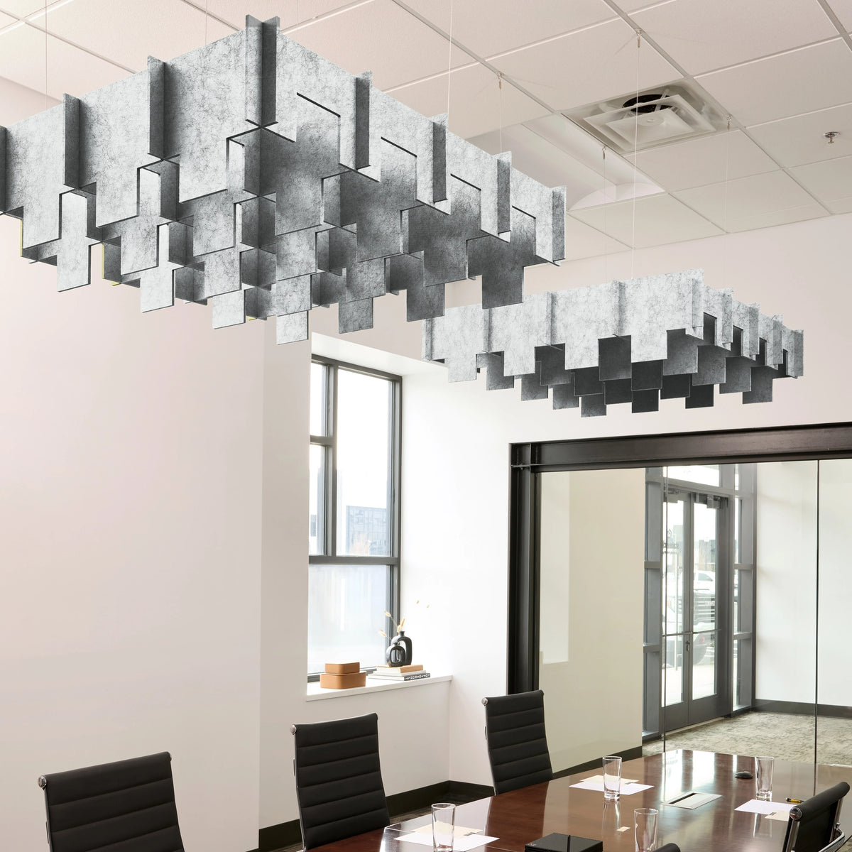 Drop 3D Cloud acoustic ceiling baffles in Nickel felt above a conference table