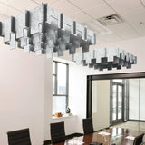 Drop 3D Cloud acoustic ceiling baffles in Nickel felt above a conference table