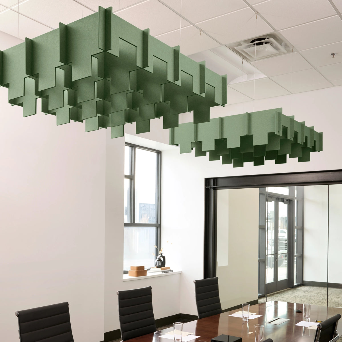Drop 3D Cloud acoustic ceiling baffles in Palm felt above a conference table
