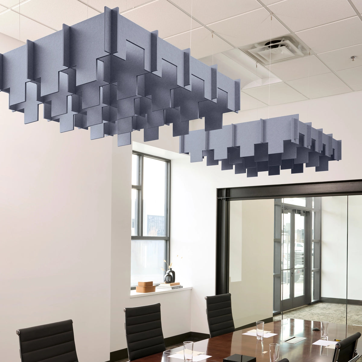 Drop 3D Cloud acoustic ceiling baffles in Periwinkle felt above a conference table