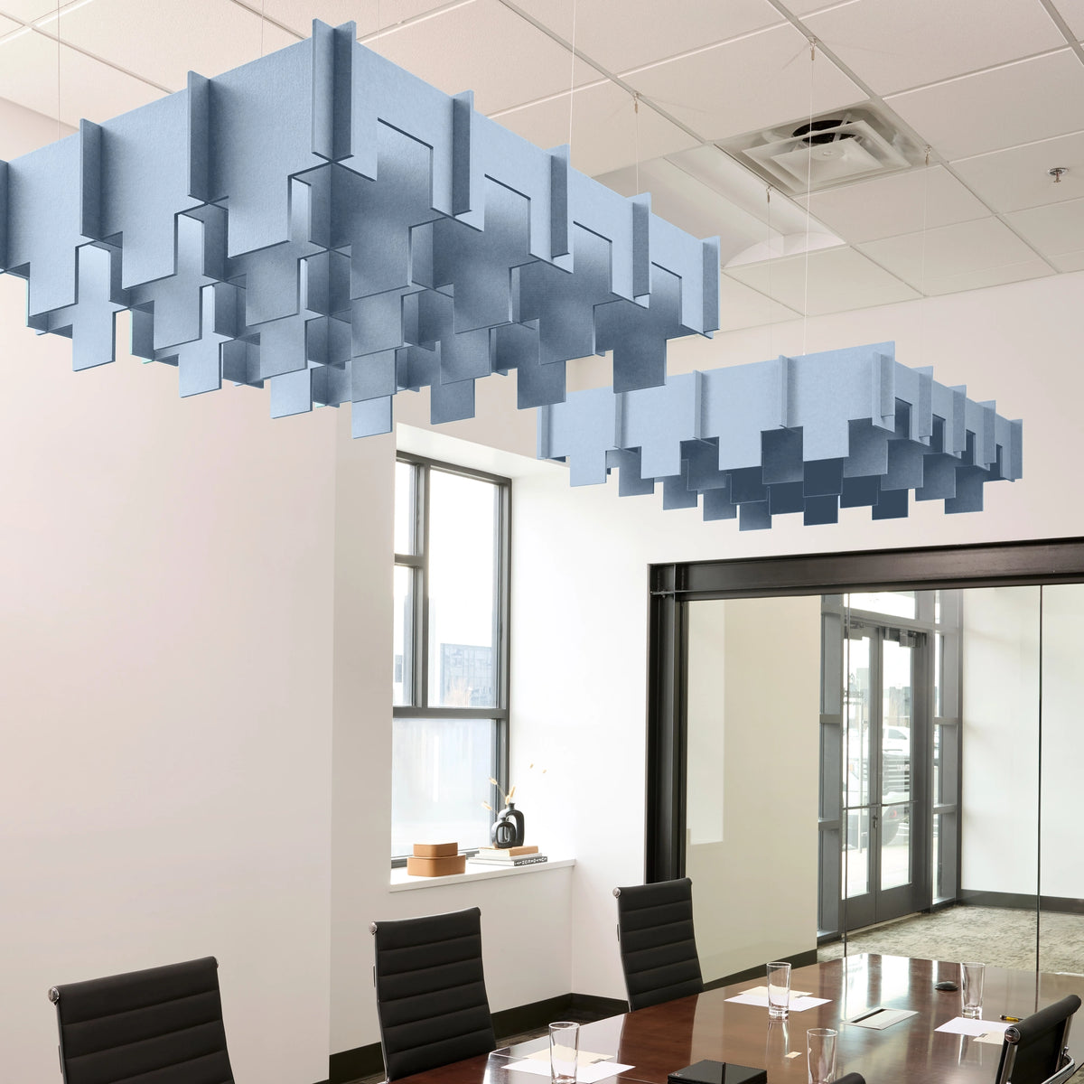 Drop 3D Cloud acoustic ceiling baffles in Powder Blue felt above a conference table