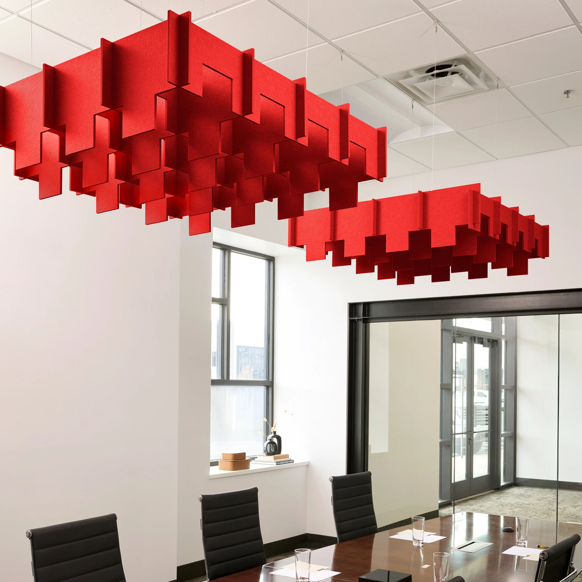 Drop 3D Cloud acoustic ceiling baffles in Scarlet felt above a conference table