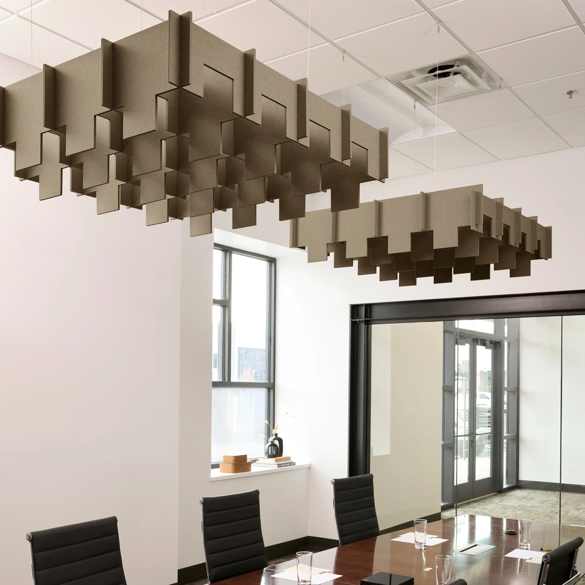 Drop 3D Cloud acoustic ceiling baffles in Timber felt above a conference table
