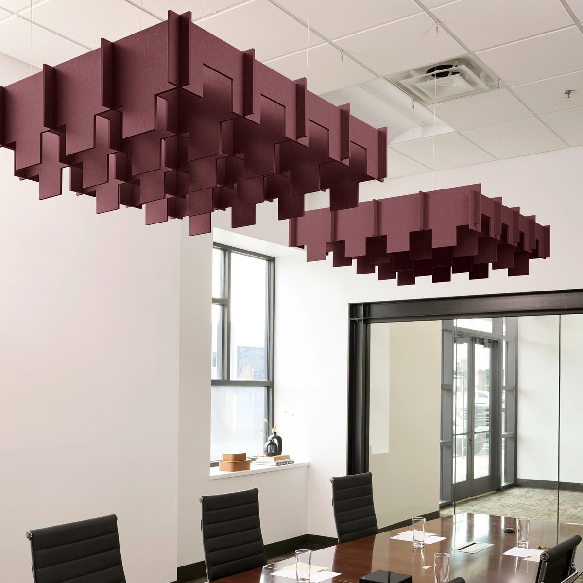 Drop 3D Cloud acoustic ceiling baffles in Wine felt above a conference table
