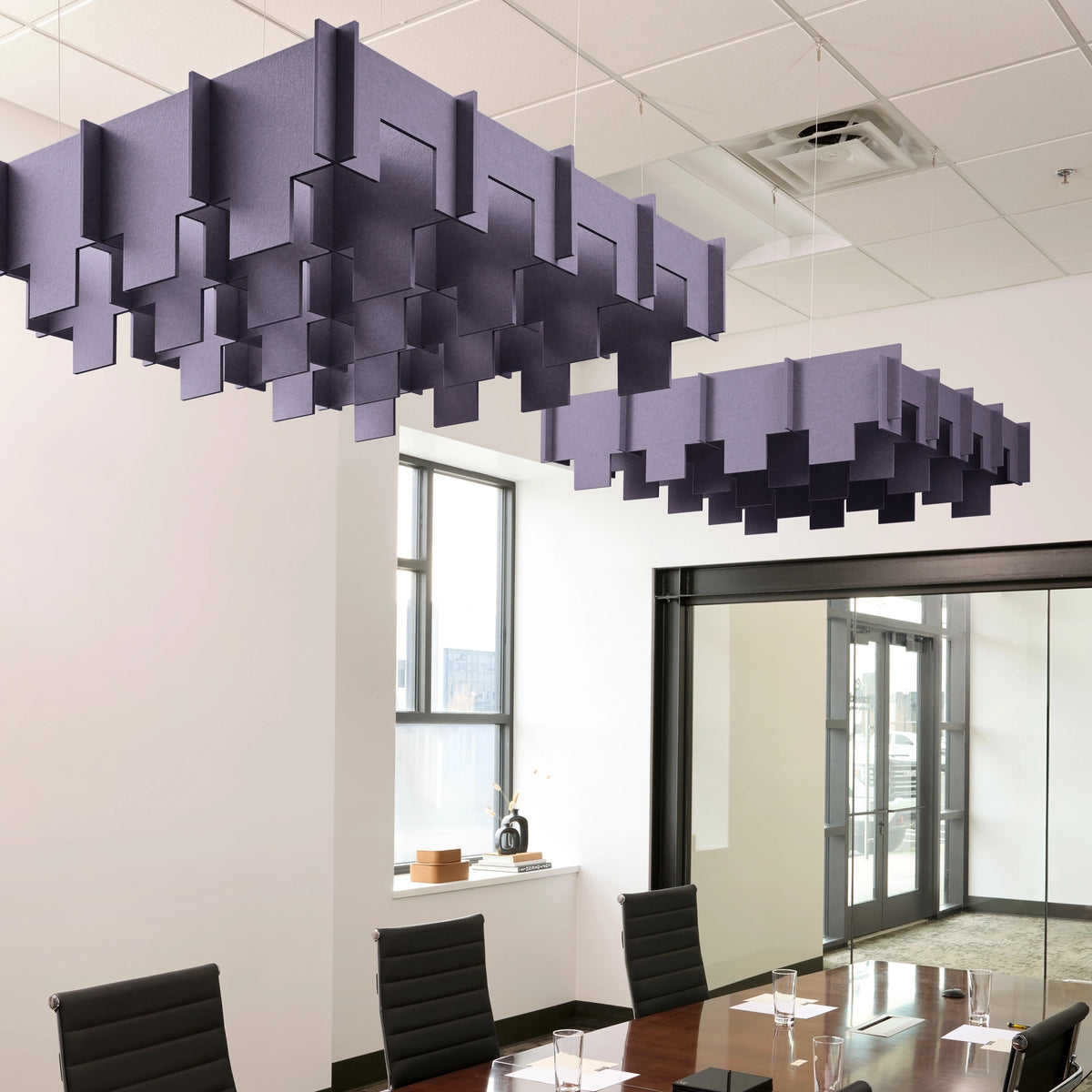 Drop 3D Cloud acoustic ceiling baffles in Wisteria felt above a conference table