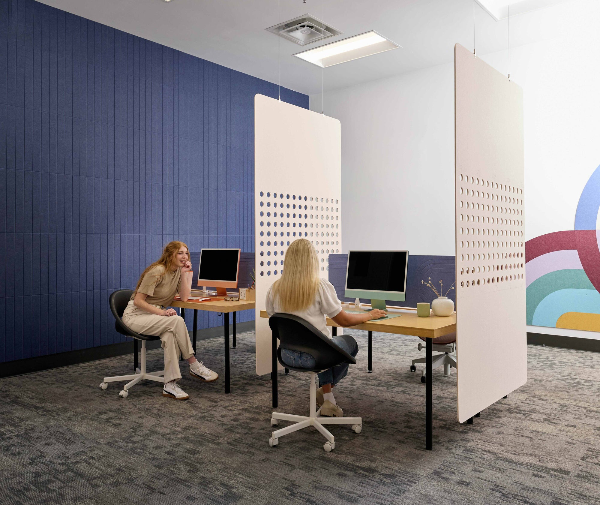 Two cream room dividers in a shared office space