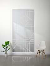 Gray layered felt sheet with white engraved subway map design mounted on wall.