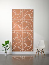 Tan felt sheet with white topographic line engraving in grid pattern, displayed vertically on wall.