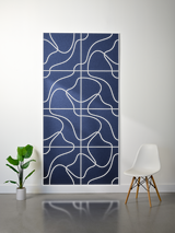 Navy blue felt sheet with white engraved topographic contour lines in a gridded pattern.