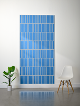 Blue felt sheet with white engraved linear pattern creating offset rectangular sections throughout.