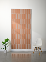 Terracotta and white layered felt sheet with offset engraved vertical stripe pattern displayed on wall.