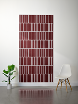Burgundy and white felt sheet with offset engraved geometric grid pattern, mounted on wall.