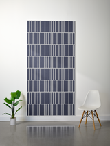 Dark blue and white layered felt sheet with offset engraved geometric grid pattern.