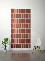Terracotta felt sheet with white engraved linear pattern creating offset rectangular sections throughout.