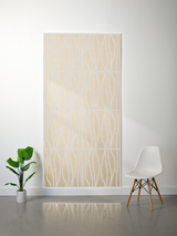 Beige felt sheet with white wavy line engravings in grid pattern, displayed on wall.