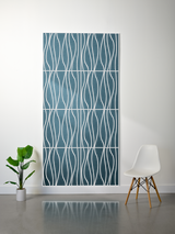 Blue-gray felt sheet with white engraved wavy vertical lines pattern and horizontal divisions creating a layered grid design.