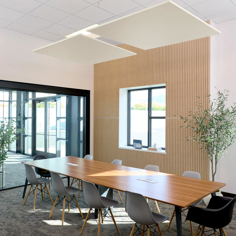Felt Right Square Flat Cloud acoustic ceiling baffles in shade of cream suspended above a modern conference table with wood slat walls