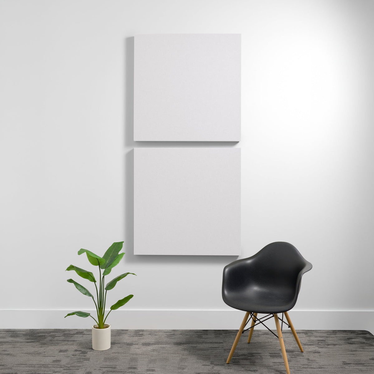 Two white square 3D acoustic panels mounted vertically on a wall.