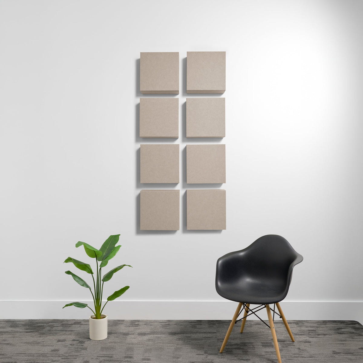 Eight square beige acoustic panels arranged in two columns on a white wall.