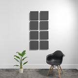 Eight dark gray square acoustic panels arranged in a 2x4 grid on a white wall.