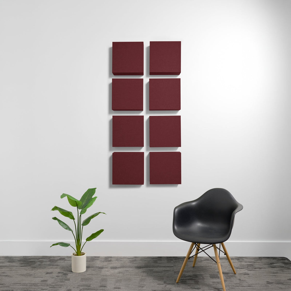 Eight deep burgundy square acoustic panels arranged in a 2x4 grid on a white wall.