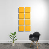 Eight yellow square acoustic panels arranged in a 2x4 grid on white wall with shadow depth.