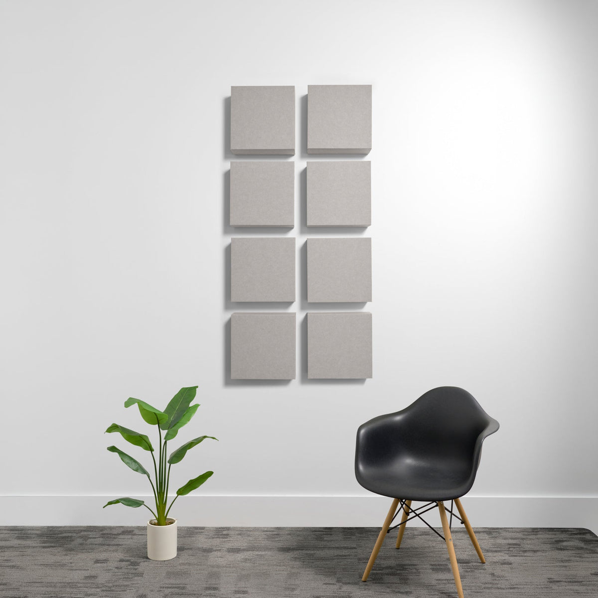 Eight light gray square acoustic panels arranged in a 2x4 grid on a white wall.