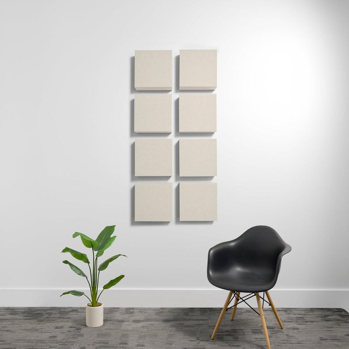 Eight square beige acoustic panels mounted on white wall in 2x4 grid arrangement.